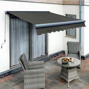 A charcoal material awning with a grey cassette. The awning fringe has a white edge