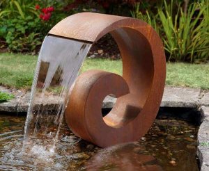 a corten steel spiral water feature sitting atop a pond